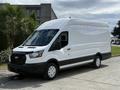 A white 2021 Ford Transit van with a high roof and large cargo space parked on a concrete surface