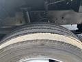 A close-up of a tire from a 2011 Workhorse W62 showing tread patterns with some dirt and wear visible on the surface