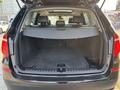 The rear trunk of a 2013 BMW X3 with a spacious cargo area and a retractable cover
