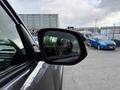 Side mirror of a 2021 Toyota 4Runner showing a reflection and part of the vehicle's interior