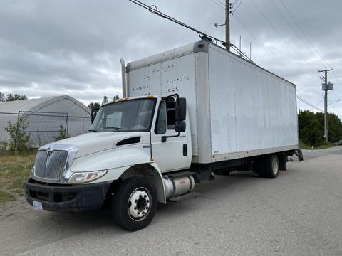 A white 2014 International Durastar box truck with a large cargo area and a front cab displaying an International logo