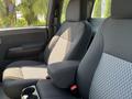 Interior of a 2011 Chevrolet Colorado showing two front seats with a mix of fabric patterns and colors
