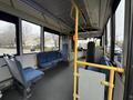 Interior of a 2016 Grande West Vicinity bus featuring blue fabric seats and yellow grab bars