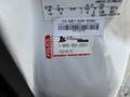 A 2009 Ford F-450 Super Duty pickup truck visible in close-up with a security label attached to the vehicle