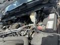 Engine compartment of a 2016 RAM 5500 showing the engine block battery and various components including hoses and a coolant reservoir