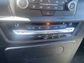 Climate control interface of a 2020 Ford Explorer featuring temperature dials air conditioning controls and buttons for fan speed and settings