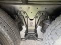 Undercarriage components of a 1996 Kenworth T800 including suspension and axle with visible bolts and markings on metal parts