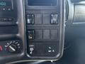 Control panel of a 2005 GMC C7500 Topkick featuring various switches and knobs for vehicle functions