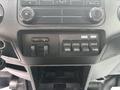 Dashboard control panel of a 2014 Ford F-550 featuring buttons for auxiliary switches and climate controls