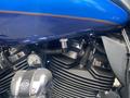 Close-up of a 2017 Harley-Davidson FLHTKL engine showcasing metallic components and blue paint with Harley-Davidson logo visible