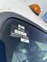 A 2015 Ford F-450 Super Duty with a certification sticker on the windshield displaying approval information and expiration details
