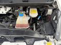 A 2020 RAM Promaster engine compartment showing the coolant reservoir and various engine components