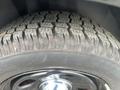 Close-up of a tire from a 2015 Dodge Charger showing deep tread patterns and a shiny black rim
