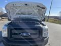 A 2016 Ford F-250 SD with the hood raised showcasing the engine compartment