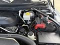 Close-up of the engine compartment of a 2020 Ram 2500 showcasing the engine, battery, coolant reservoir, and various wires and components