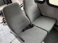 Two gray fabric seats from a 2014 Ford Econoline with armrests and seat belts