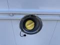 Close-up of a fuel filler cap with a yellow handle on a 2012 Ford Econoline E-450