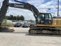 A 2018 John Deere 350 excavator with a yellow and gray exterior featuring a large bucket and tracked undercarriage positioned on a gravel surface