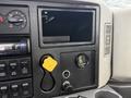 The interior dashboard of a 2013 International Workstar 7500 showing various control buttons a gauge and a yellow key holder