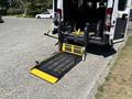 A 2016 RAM Promaster with a folded down wheelchair lift equipped with yellow and black markings and safety features