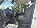 Interior of a 2023 RAM Promaster 3500 featuring two black fabric front seats with a console between them and a dashboard with gauges and controls