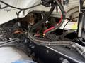 A 2016 Freightliner 108SD engine compartment showing various wiring harnesses and components with visible hoses and metal parts