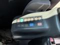 Control panel of a 2010 Bobcat E80 featuring buttons for air conditioning settings including off cool warm and fan speed adjustments