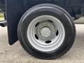 Close-up of a wheel and tire from a 2023 Ford F-450 Super Duty showcasing a silver rim and a black Continental tire
