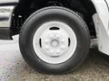 Close-up of a white wheel and tire from a 2017 Ford E450 with a black Open Country tread pattern