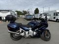 A 2016 Yamaha FJR1300AE motorcycle in blue color with a touring saddle and a rear luggage box