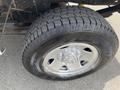 A close-up view of a tire and wheel on a 2014 Ford F-250 SD featuring a rugged tread pattern and silver alloy rim