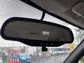 Rearview mirror of a 2011 Chevrolet Colorado featuring controls for features like auto-dimming and a built-in display