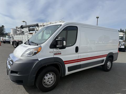 A 2017 RAM Promaster van with a white body and red stripe on the side parked in a lot