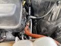A close-up view of the engine compartment of a 2021 Ford Explorer showcasing various components including hoses and wiring