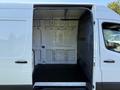 Interior view of a 2020 Mercedes-Benz Sprinter van with open side door showcasing the cargo space and wall paneling