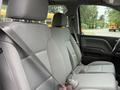 Interior view of a 2016 GMC Sierra 1500 showing the front passenger and driver seats with gray upholstery and seatbelts