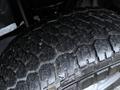Close-up of a tire on a 2023 Ford F-250 showing the tread pattern and details of the rubber surface