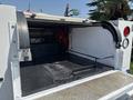 A 2017 Chevrolet Colorado with an open truck bed showcasing a black rubberized floor and mounted equipment inside