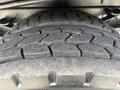 Close-up of a rugged tire from a 2018 Ford F-750 showcasing deep tread patterns designed for off-road capability and heavy loads