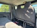 Interior view of a 2011 International 4300 showing three gray fabric seats and a simple, utilitarian cabin design