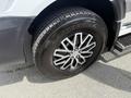 A close-up view of a black tire mounted on a chrome alloy wheel with five spokes from a 2016 Mercedes-Benz Sprinter