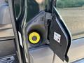 A close-up of a fuel filler door on a 2016 Ford Transit 150 revealing a yellow fuel cap and labels for refueling instructions