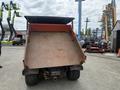 A 2011 Kubota RTV 1140 CPX utility vehicle with a lowered dump bed showing a textured metal surface and rear tires visible