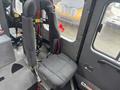 Interior view of a 2006 E-One Typhoon featuring a black driver's seat and a passenger seat with safety harnesses attached