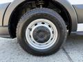 A close-up view of a silver wheel with a Goodyear Wrangler tire mounted on a 2022 Ford Transit vehicle