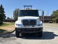 A white 2011 International 4300 truck facing forward with a chrome grille and two side mirrors