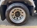 Close-up view of a Goodyear tire mounted on a shiny silver rim belonging to a 2020 Peterbilt 330 truck