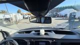 Interior view of a 2021 Ford Transit showing the dashboard and rearview mirror with digital display