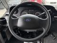 Steering wheel and dashboard of a 2018 Ford Econoline with speedometer and other gauges visible