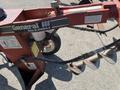 A red General 660H Dig-R-Mobile Auger with a large auger bit attached and various hoses and labels visible on its frame